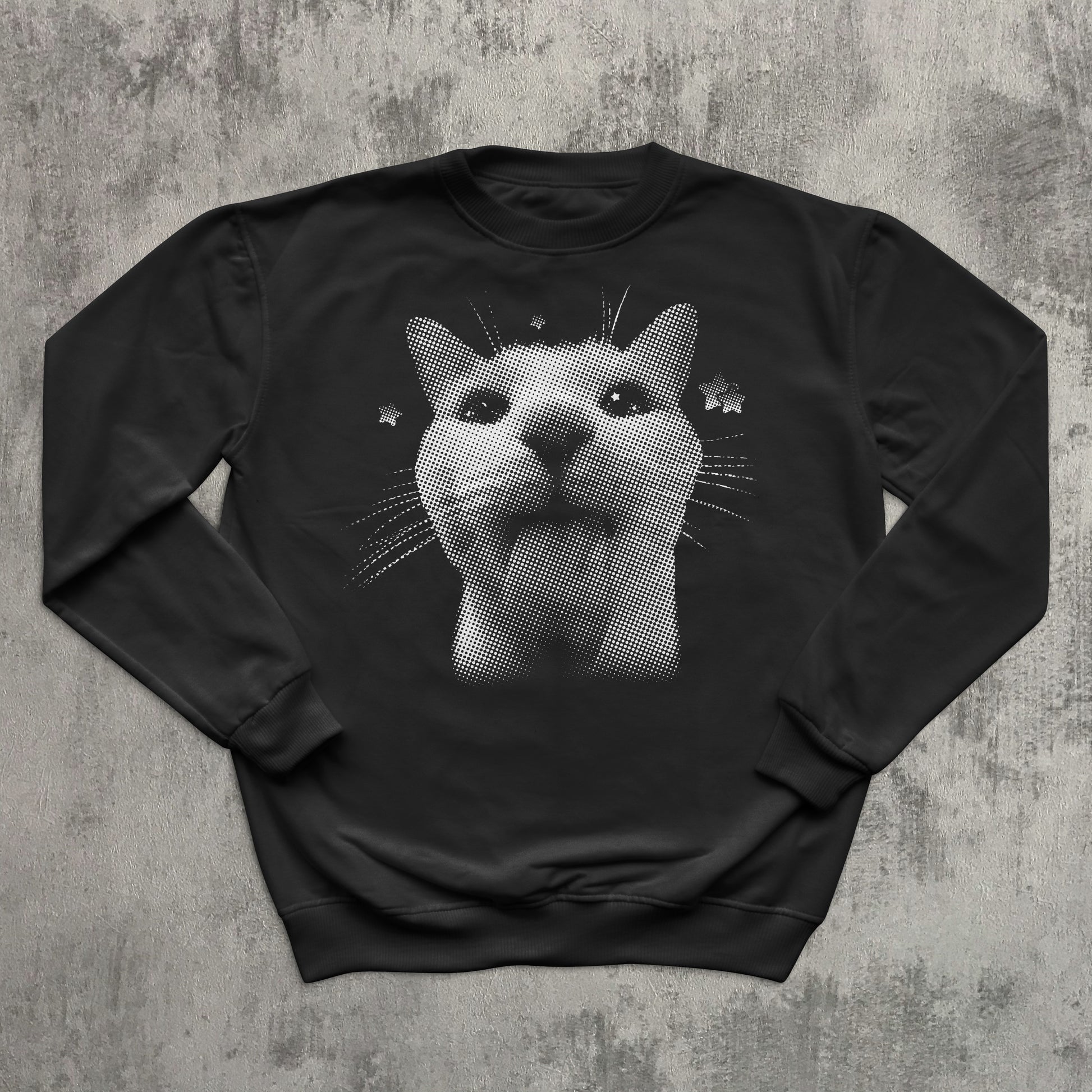 Black sweatshirt with a cat graphic on a textured gray background