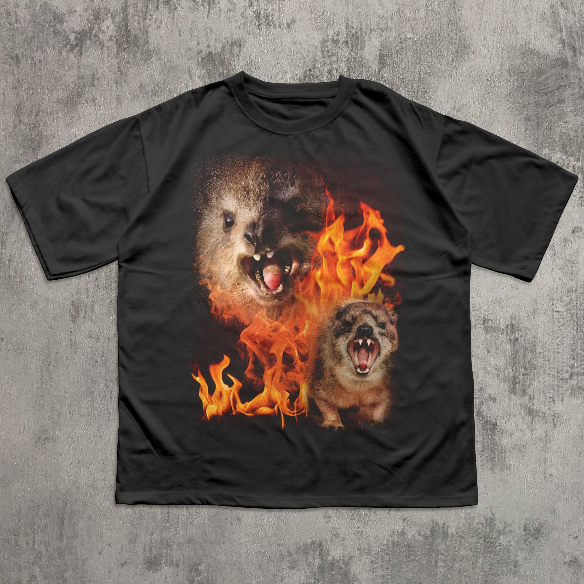 Black t-shirt with a graphic of two hyraxes in flames on a textured gray background