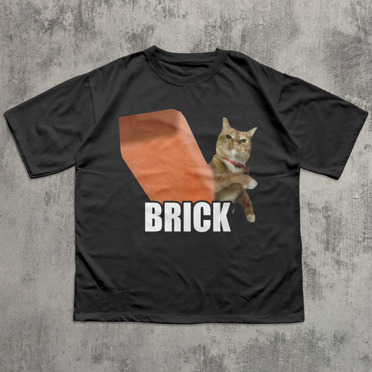 Black t-shirt with a graphic of a cat labeled 'BRICK' on a textured gray background