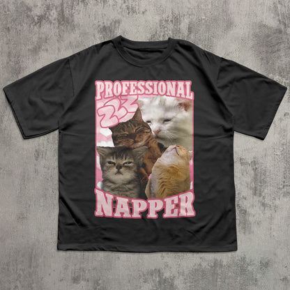 Funny Black t-shirt with a graphic of cats and the text 'Professional Napper' on a textured gray background
