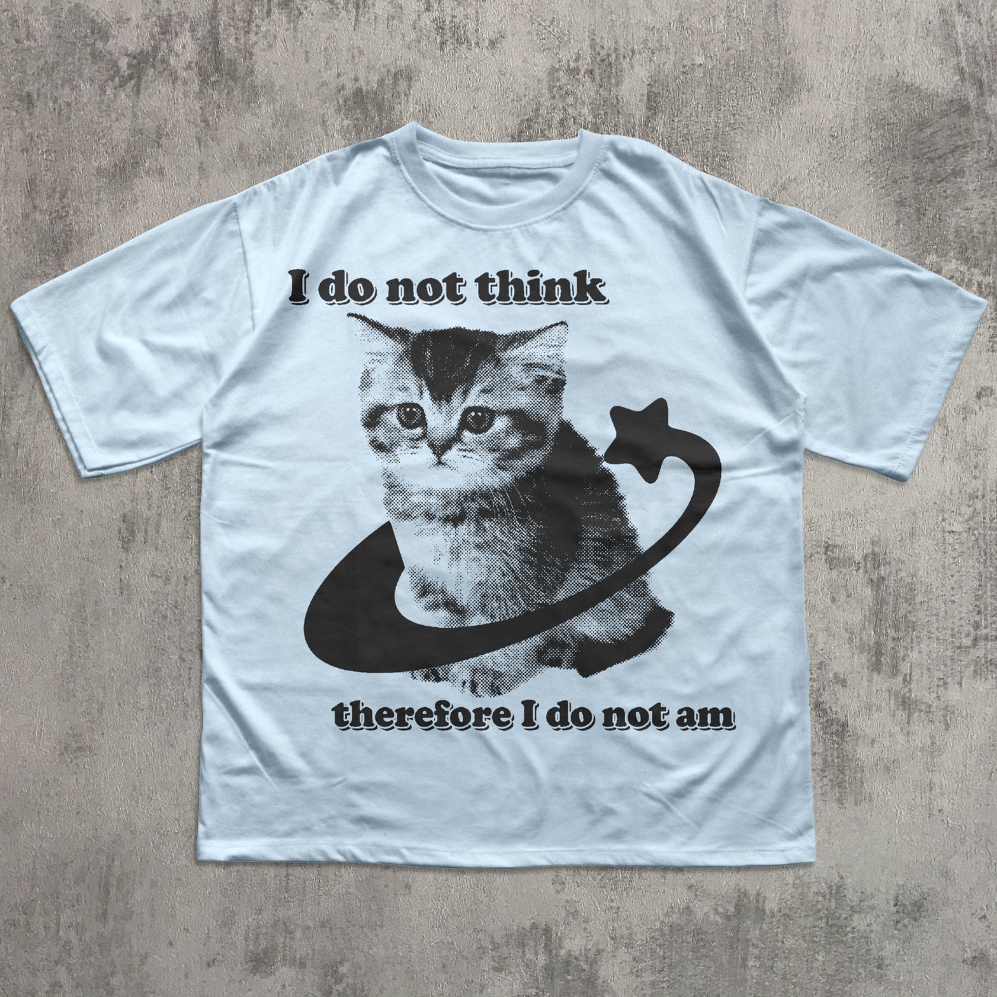 White t-shirt with a cat graphic and text on a textured surface