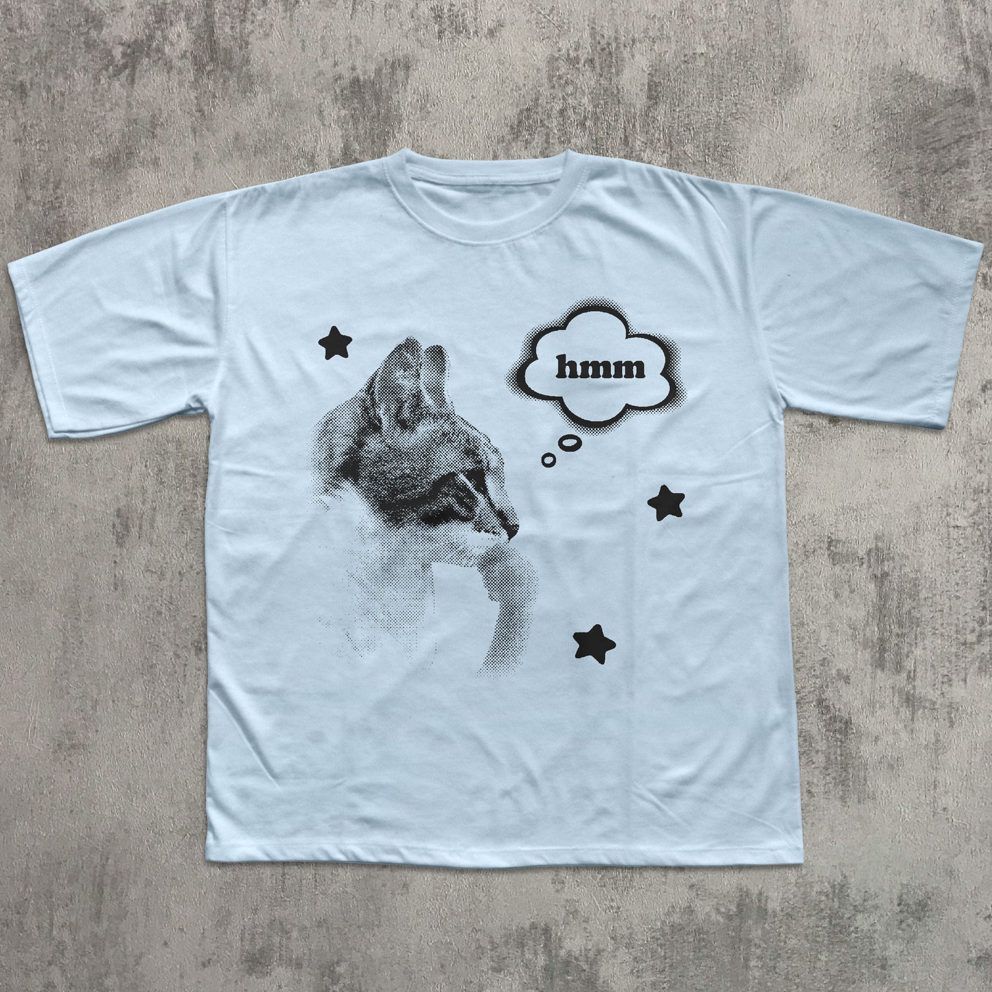 White t-shirt with a graphic of a cat and 'hmm' text on a textured gray background