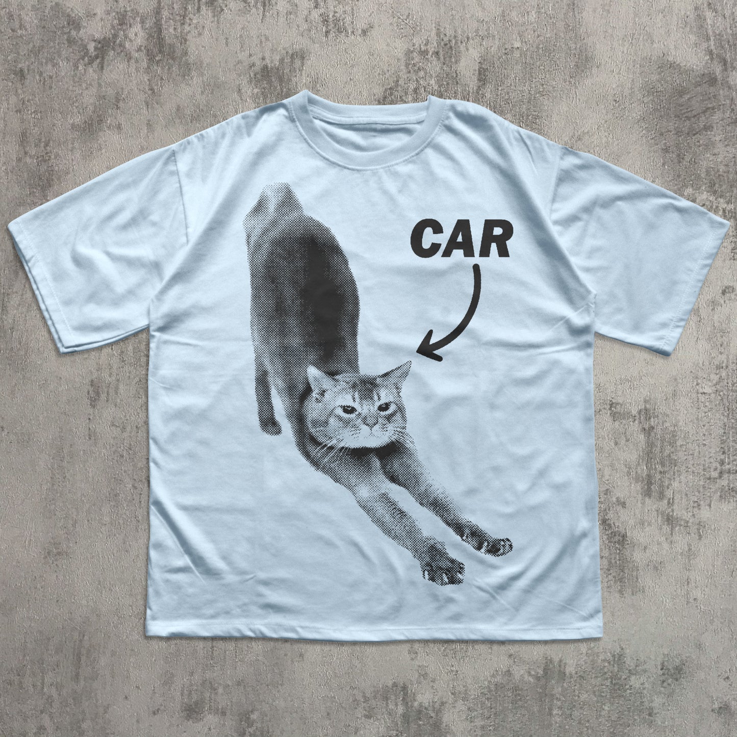 White t-shirt with a graphic of a cat labeled 'CAR' on a textured surface