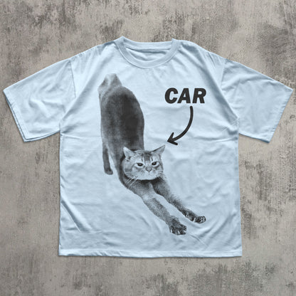 White t-shirt with a graphic of a cat labeled 'CAR' on a textured surface