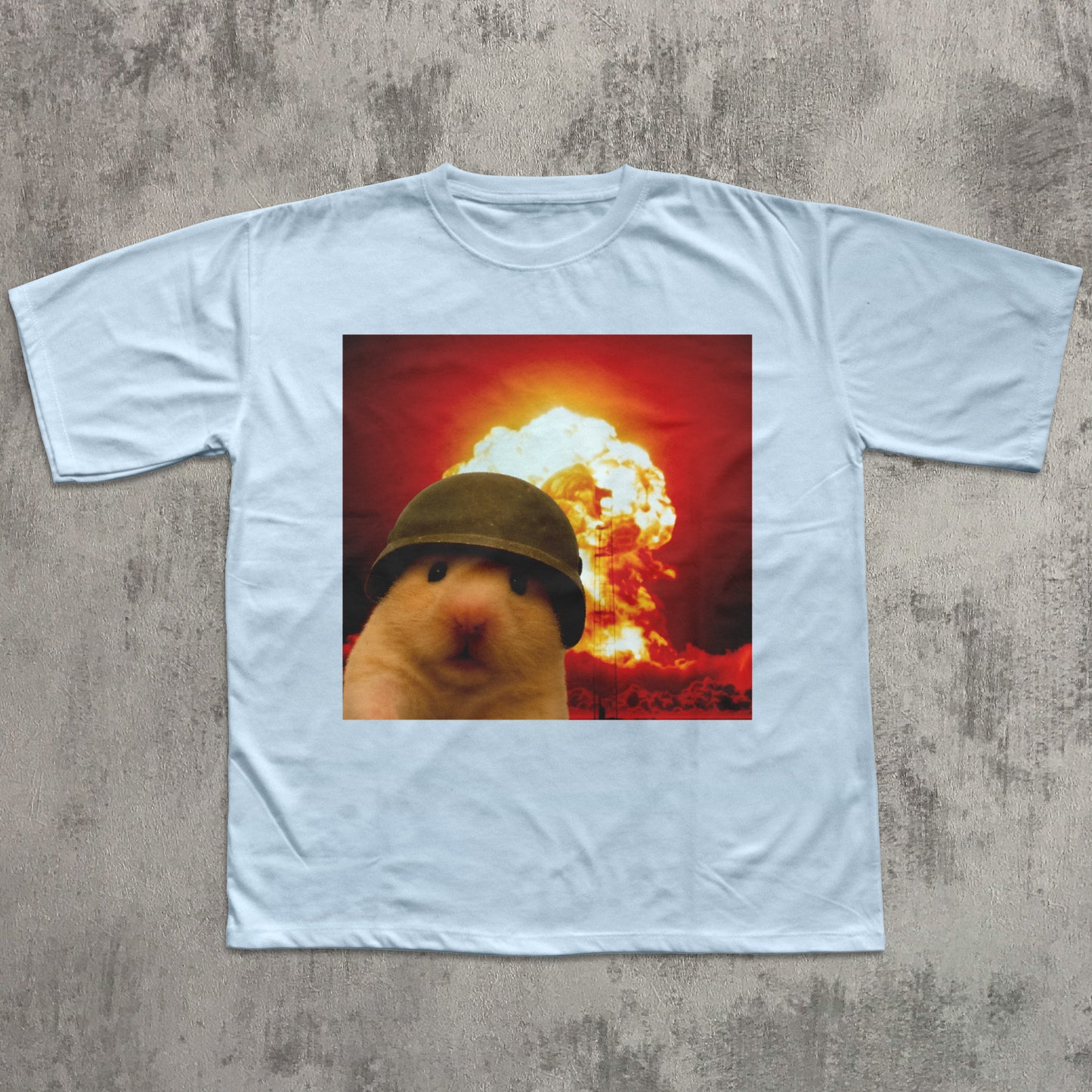 White t-shirt with a graphic of a hamster wearing a helmet in front of an explosion on a textured gray background