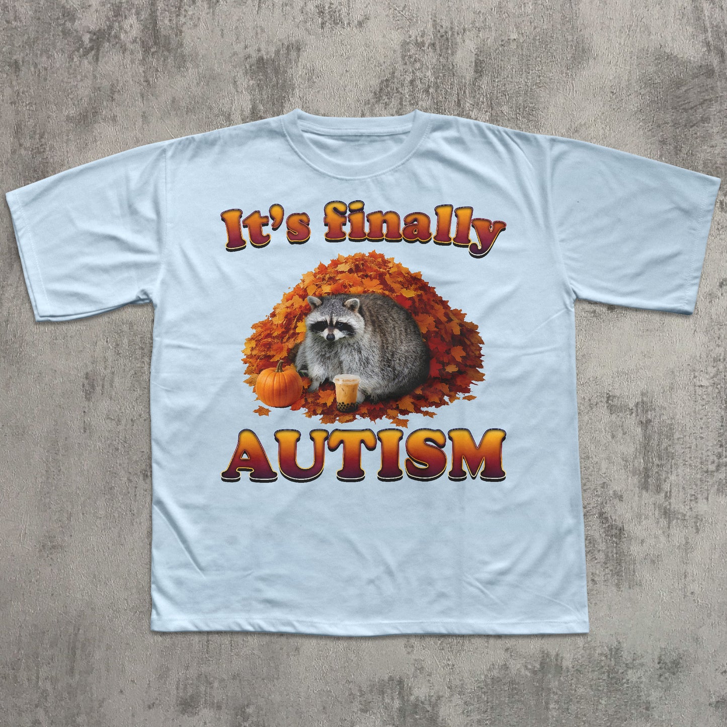 Light blue t-shirt with a raccoon graphic and text on a concrete surface