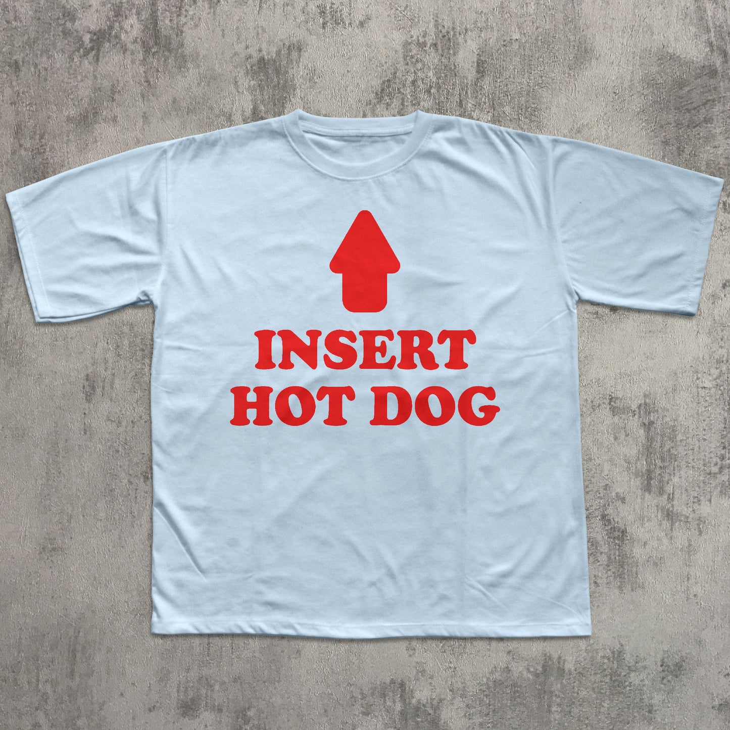 Light blue t-shirt with red graphic and text 'Insert Hot Dog' on a concrete surface