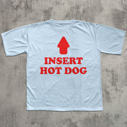 Light blue t-shirt with red graphic and text 'Insert Hot Dog' on a concrete surface