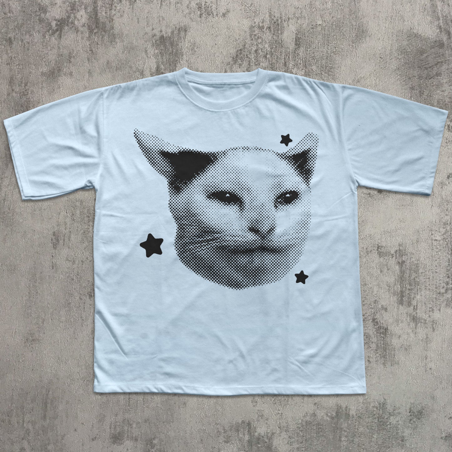 White t-shirt with a black cat graphic on a textured gray surface