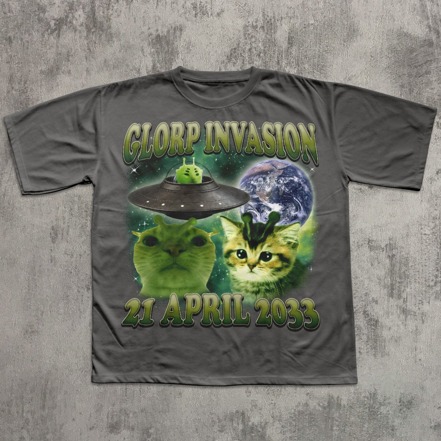 Gray t-shirt with alien invasion design featuring cats and a UFO on a concrete background