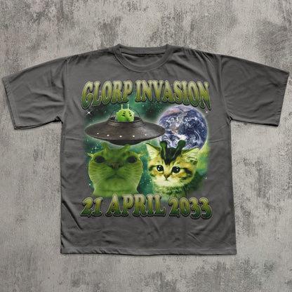 Gray t-shirt with alien invasion design featuring cats and a UFO on a concrete background
