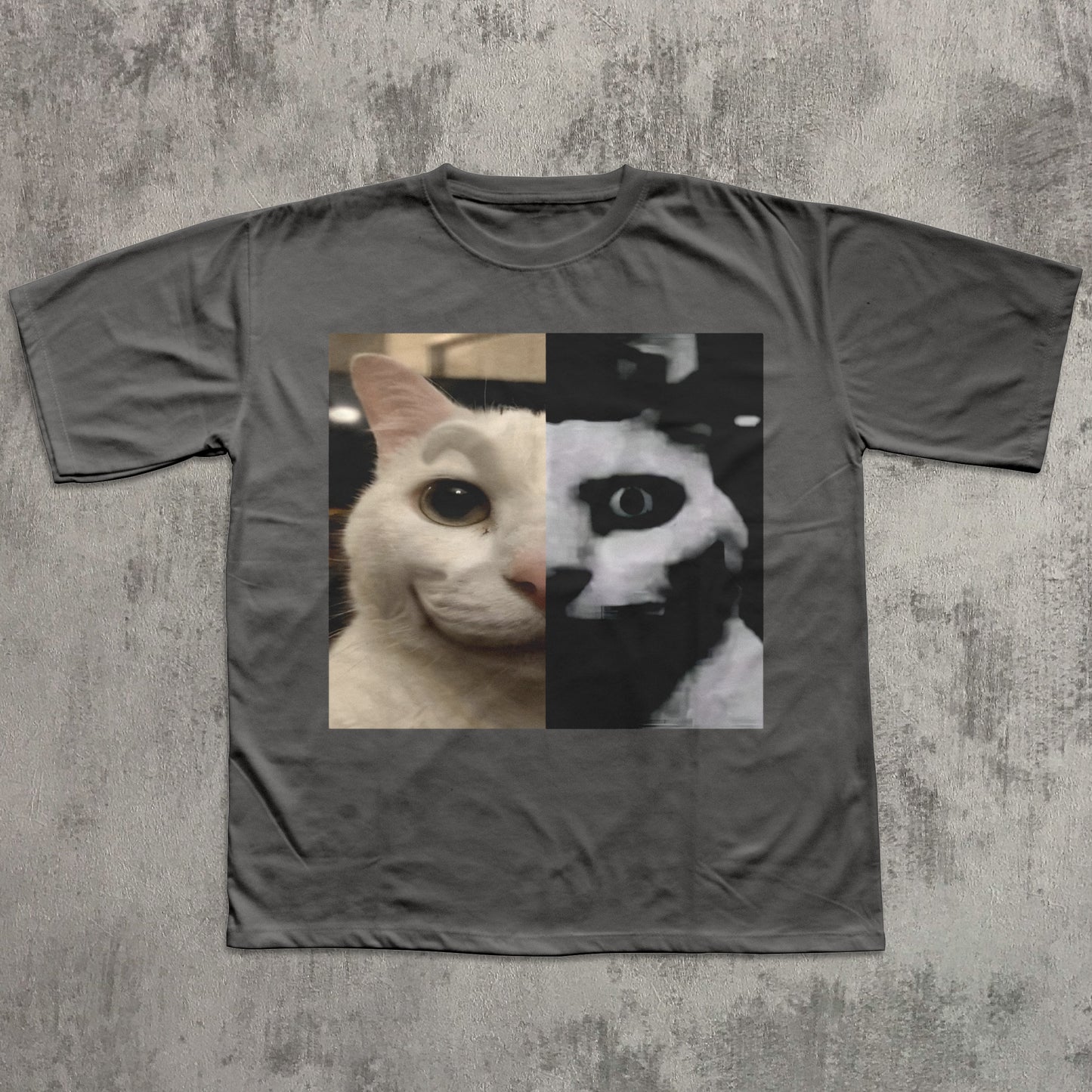 Gray t-shirt with a cat face design on a textured gray background