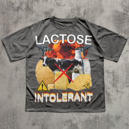 Gray t-shirt with a graphic design featuring cows, cheese, and text on a concrete background