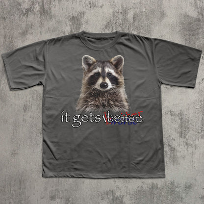 Gray t-shirt with a raccoon graphic and text on a textured gray background