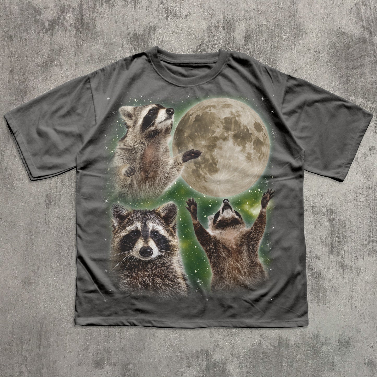 T-shirt with raccoon design and moon on a textured gray background