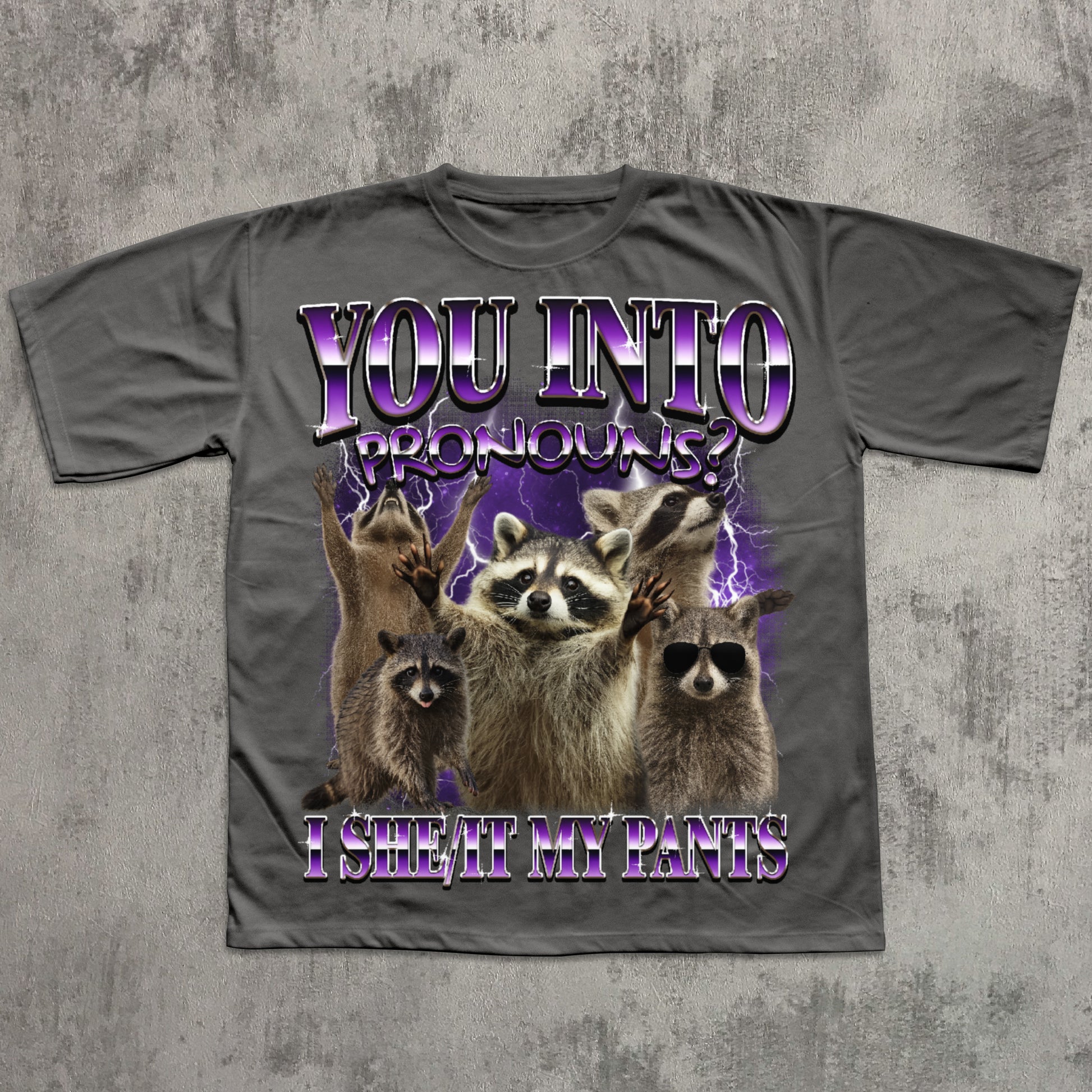 Gray t-shirt with raccoon graphic and humorous text on a textured gray background