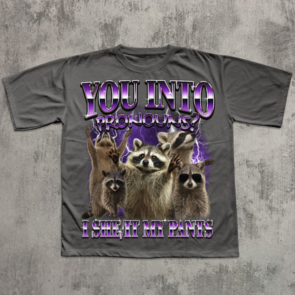 Gray t-shirt with raccoon graphic and humorous text on a textured gray background