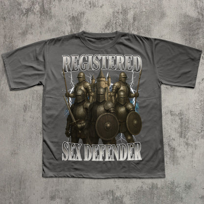 Gray t-shirt with warrior graphic and text 'REGISTERED SEX DEFENDER' on a textured gray background
