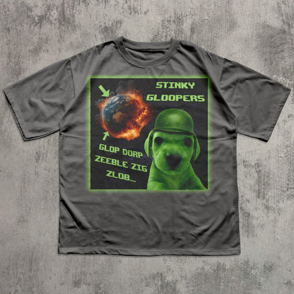 Gray funny t-shirt with a graphic design featuring a green alien dog and text on a concrete background