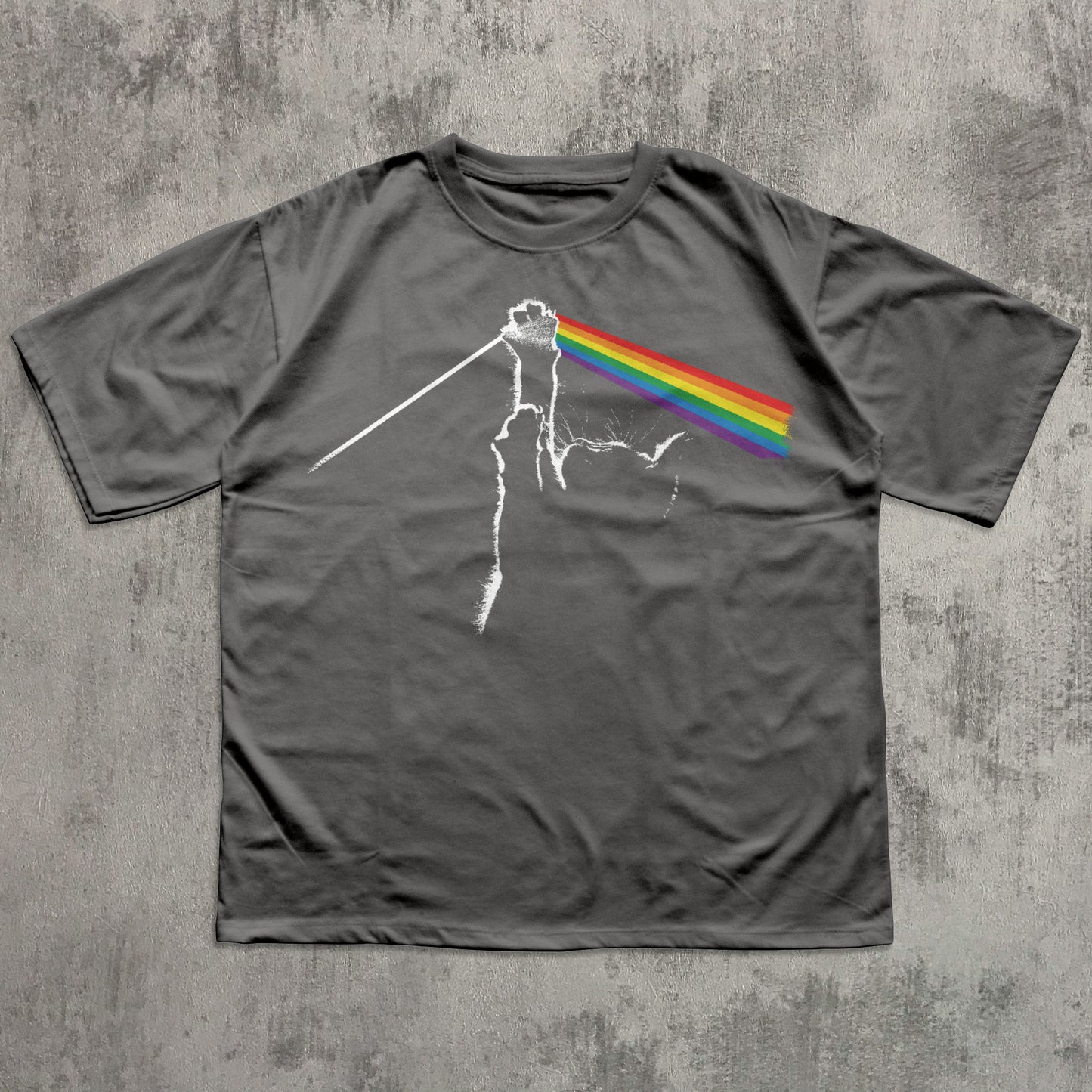 Gray t-shirt with a graphic design of a rainbow on a concrete surface