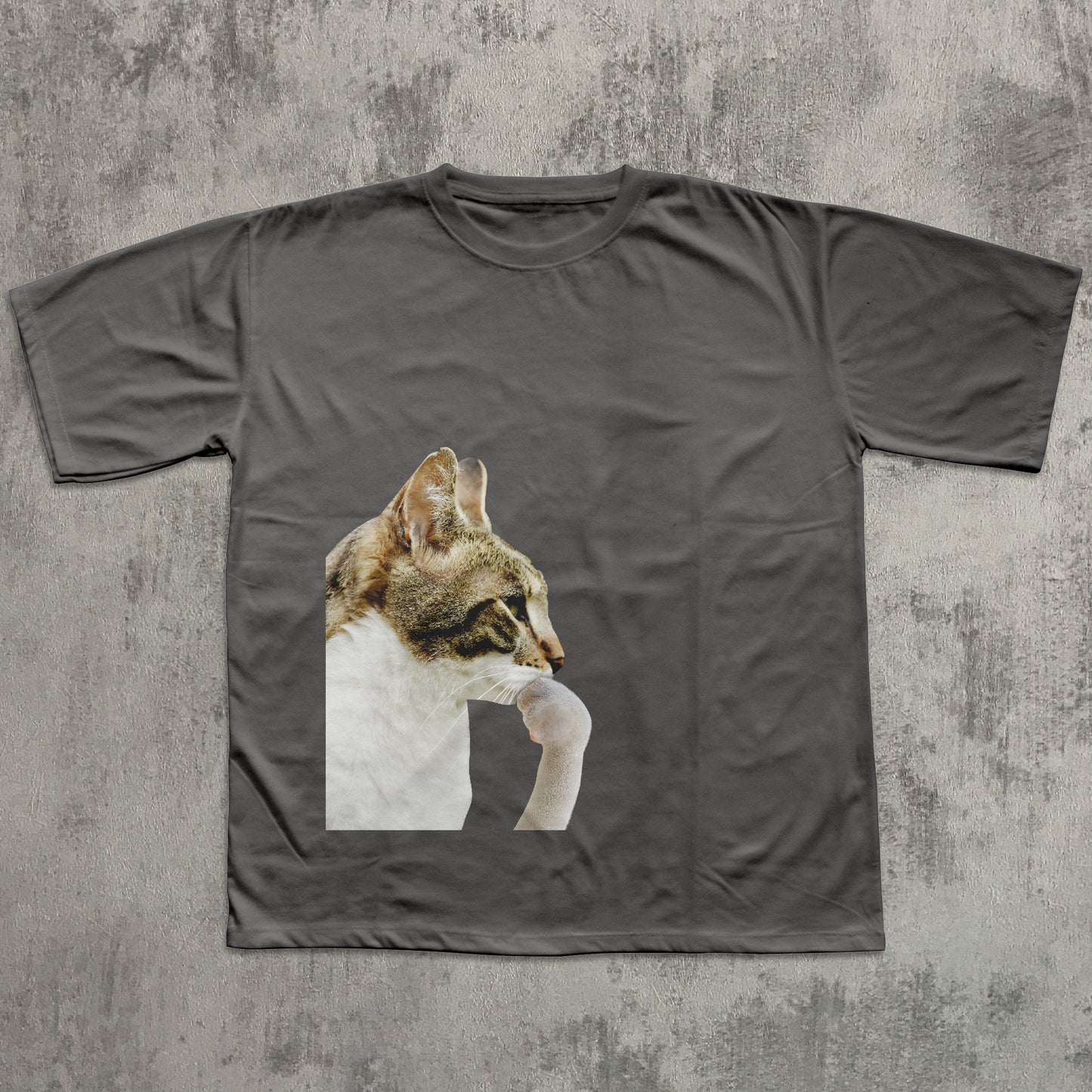 Gray t-shirt with a cat graphic on a textured gray background