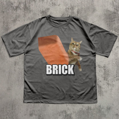 Gray t-shirt with a cat graphic and 'BRICK' text on a textured gray background
