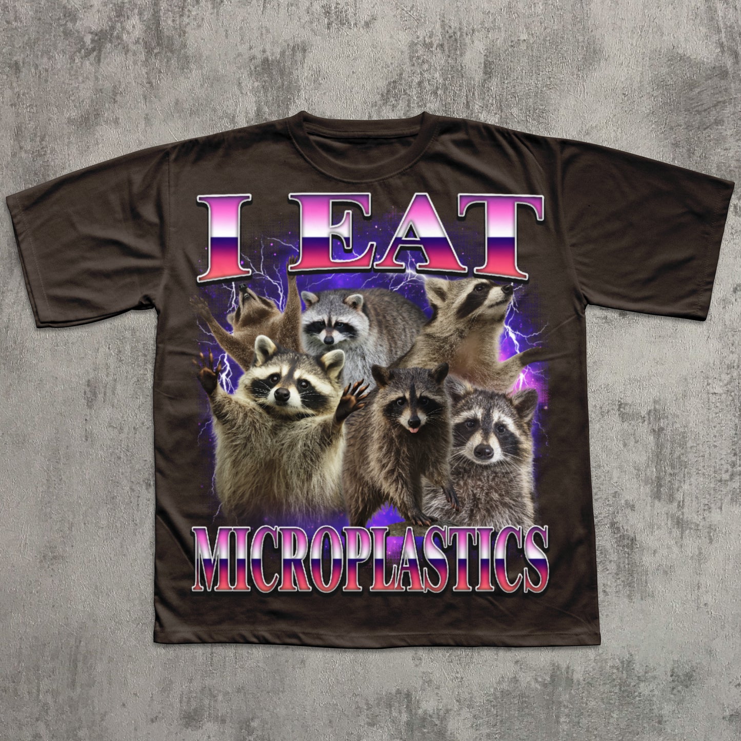 T-shirt with raccoons and text 'I Eat Microplastics' on a textured gray background