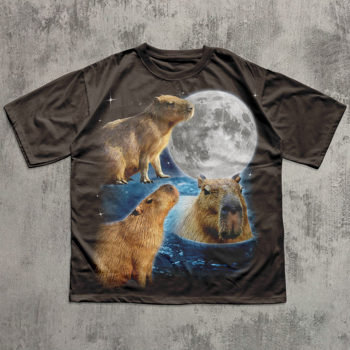 T-shirt with capybara design and moon on a textured gray background