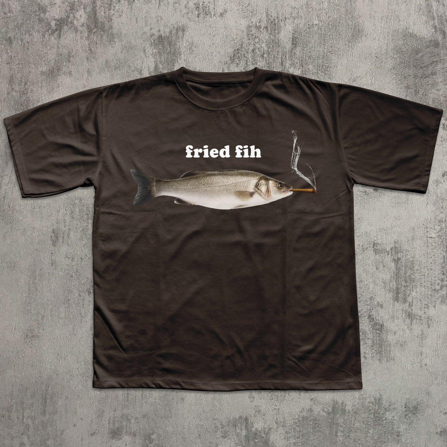 Brown t-shirt with a fish graphic and 'fried fih' text on a textured gray background