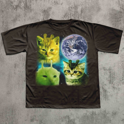 Black t-shirt with alien and cat design on a textured gray background