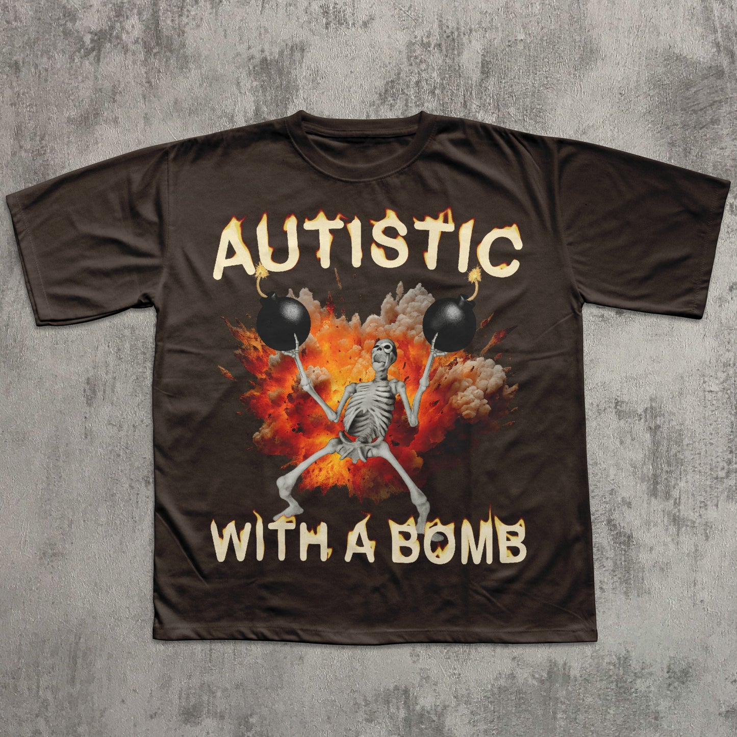 Brown t-shirt with a skeleton holding bombs and 'Autistic with a Bomb' text on a concrete background