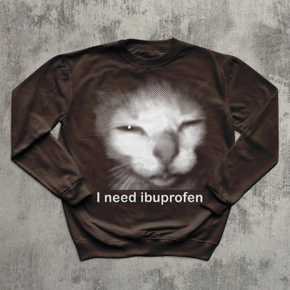 Brown sweatshirt featuring funny distressed cat meme with text ‘I need ibuprofen.
