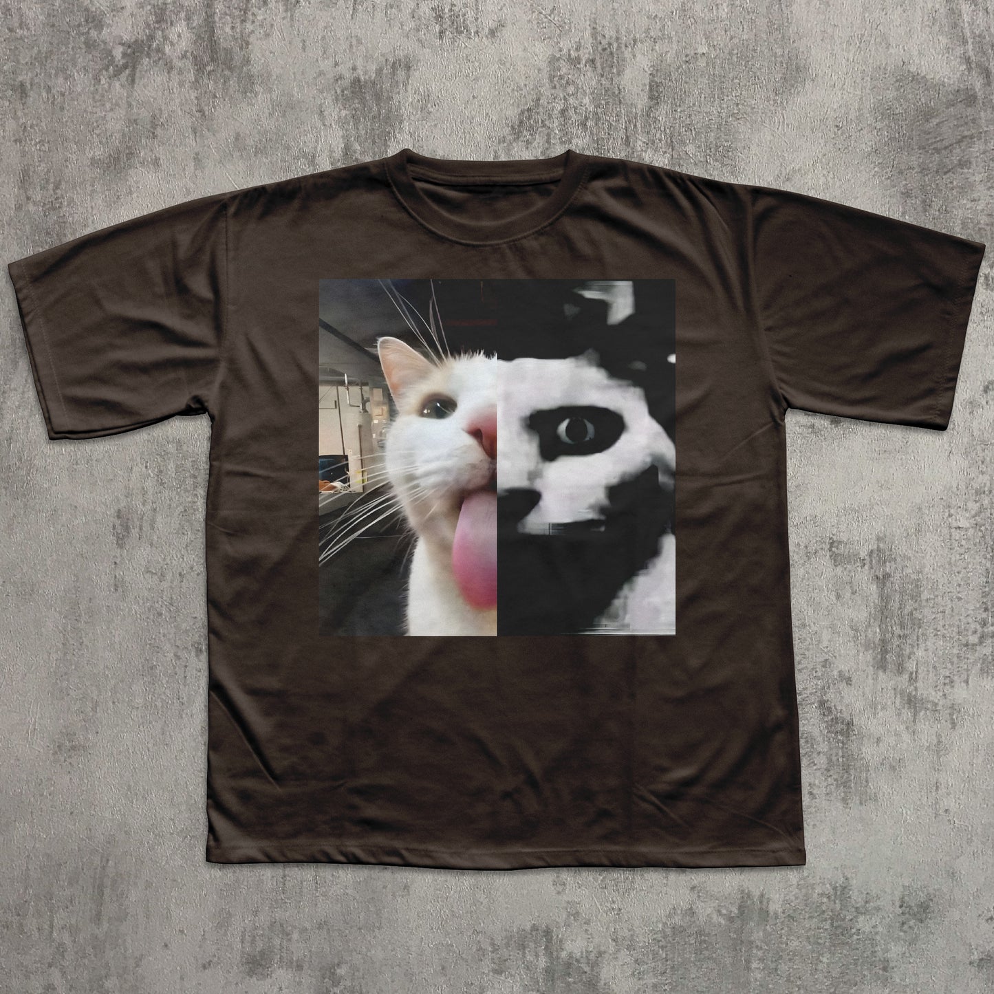 Brown t-shirt with a graphic of a cat's face on a textured gray background
