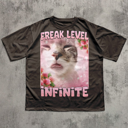 Funny T-shirt with a cat graphic and text 'Freak Level Infinite' on a textured gray background
