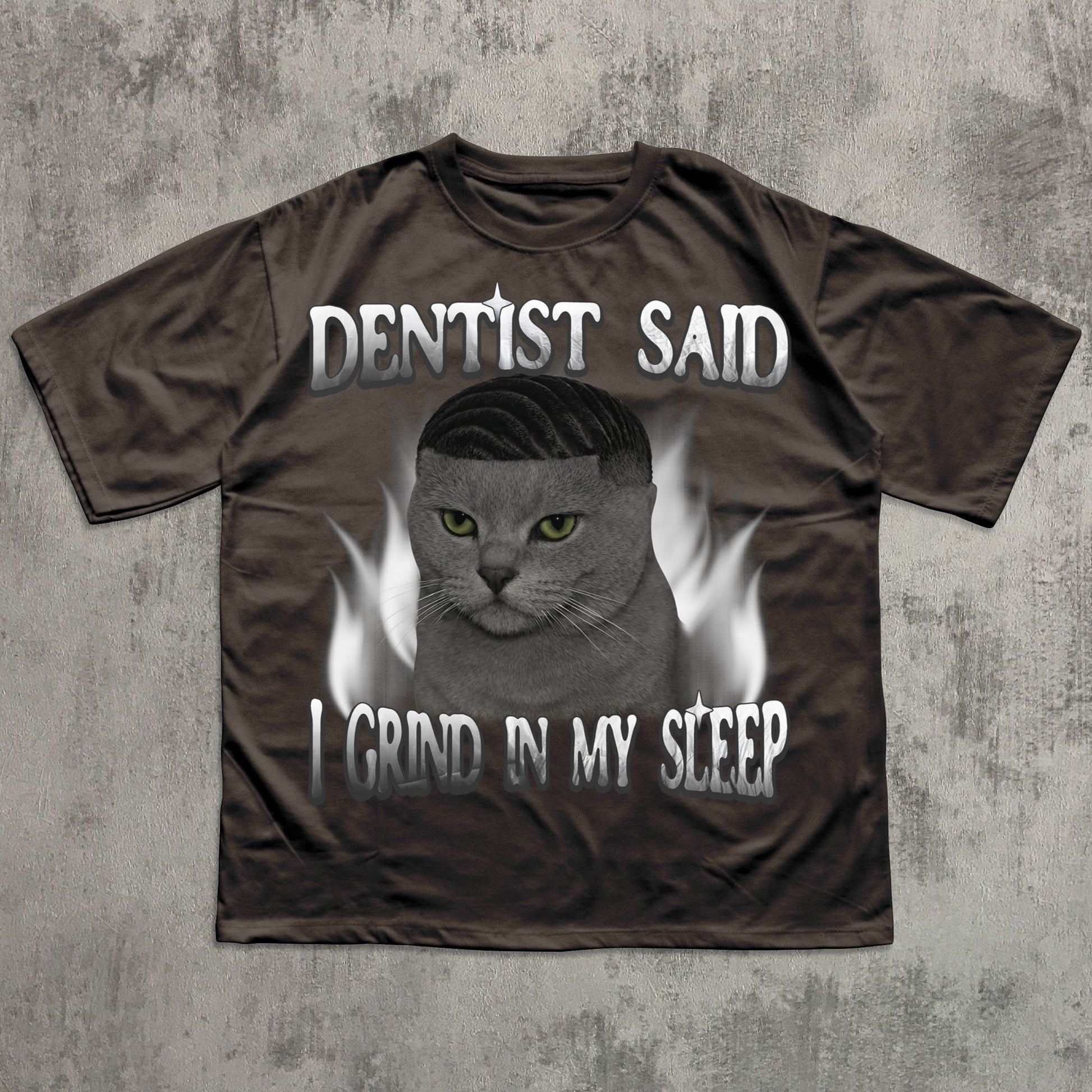 Brown t-shirt with a graphic of a cat and text on a textured gray background