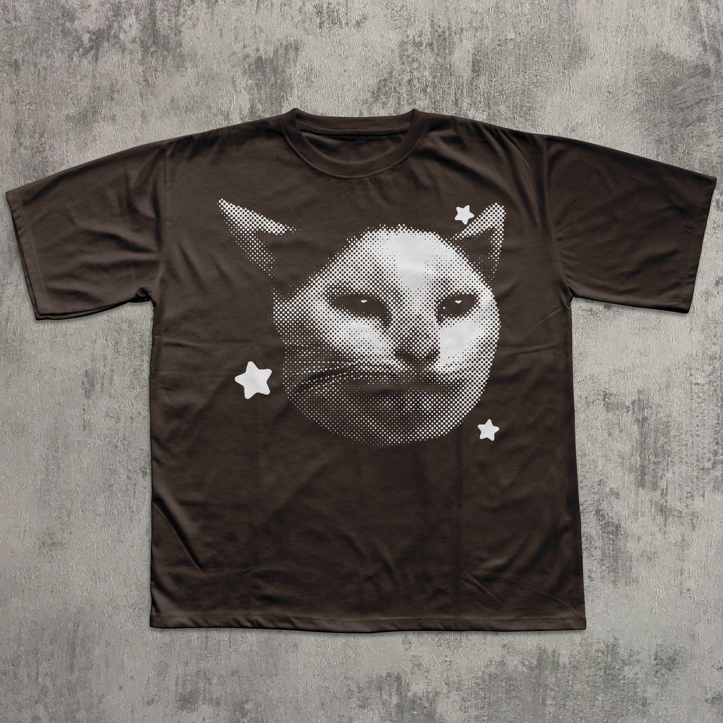 Brown t-shirt with a black and white cat graphic on a textured gray background
