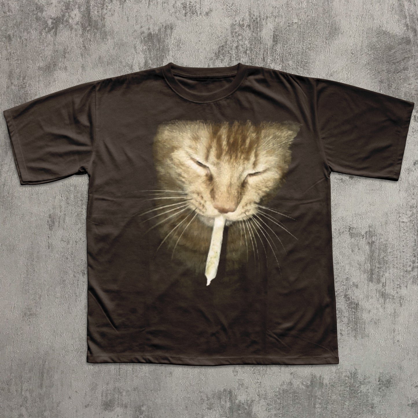 Brown t-shirt with a cat graphic on a textured gray background