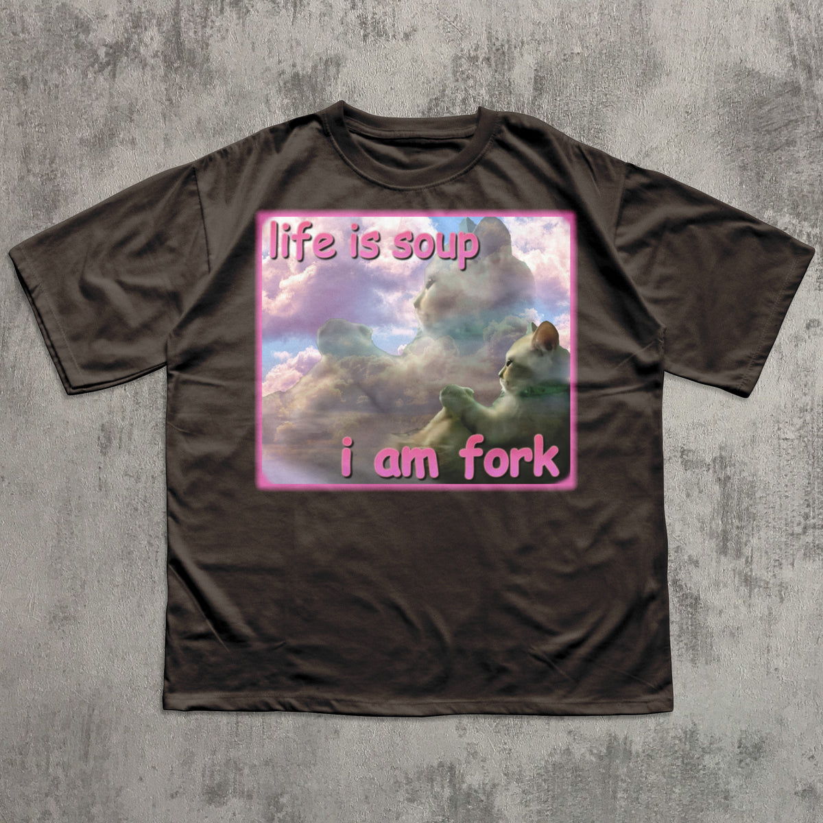 Brown t-shirt with a graphic design and text on a textured gray background