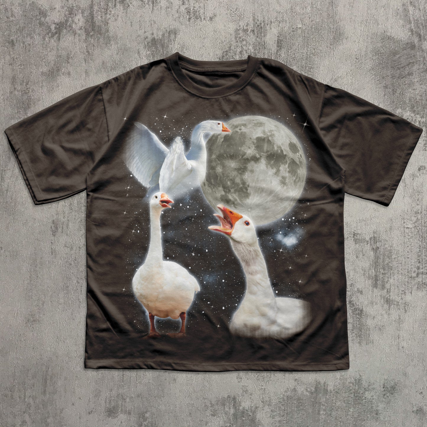 T-shirt with a graphic of three geese and a moon on a textured gray background