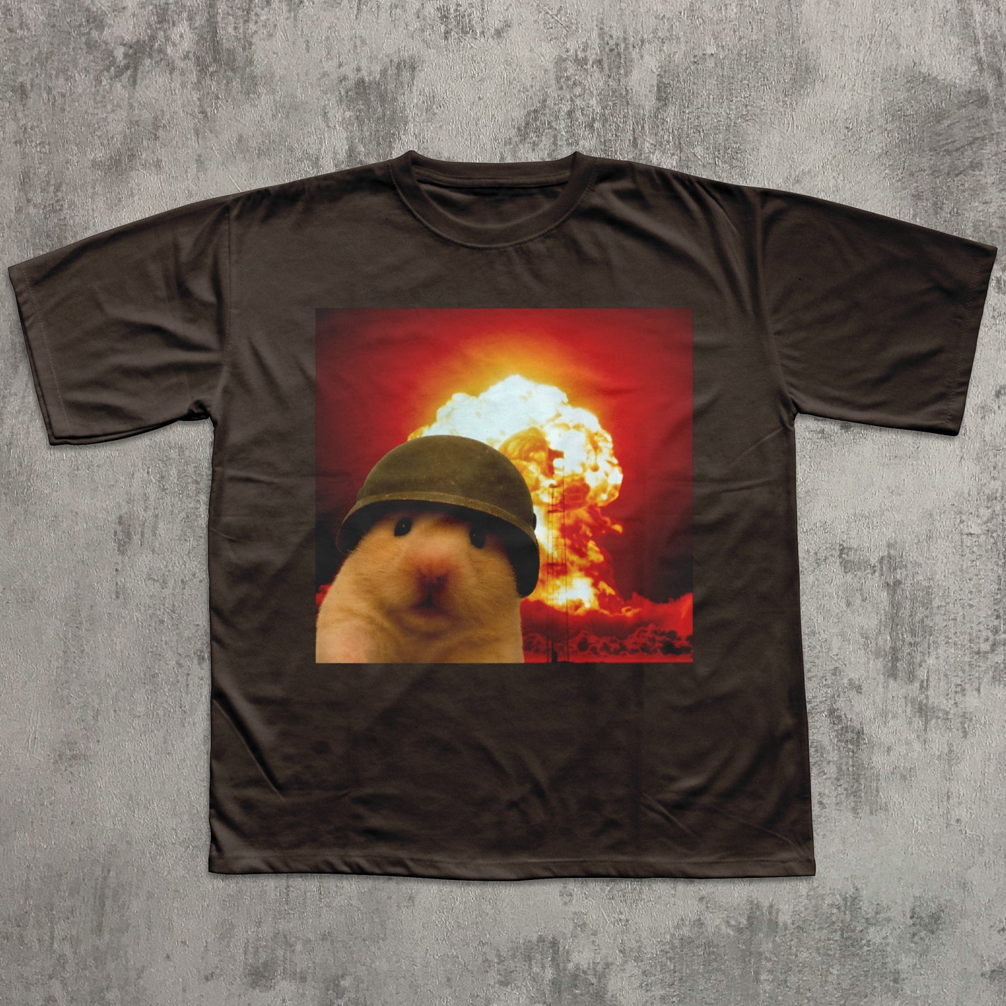 Brown t-shirt with a graphic of a hamster wearing a helmet in front of an explosion on a textured gray background.