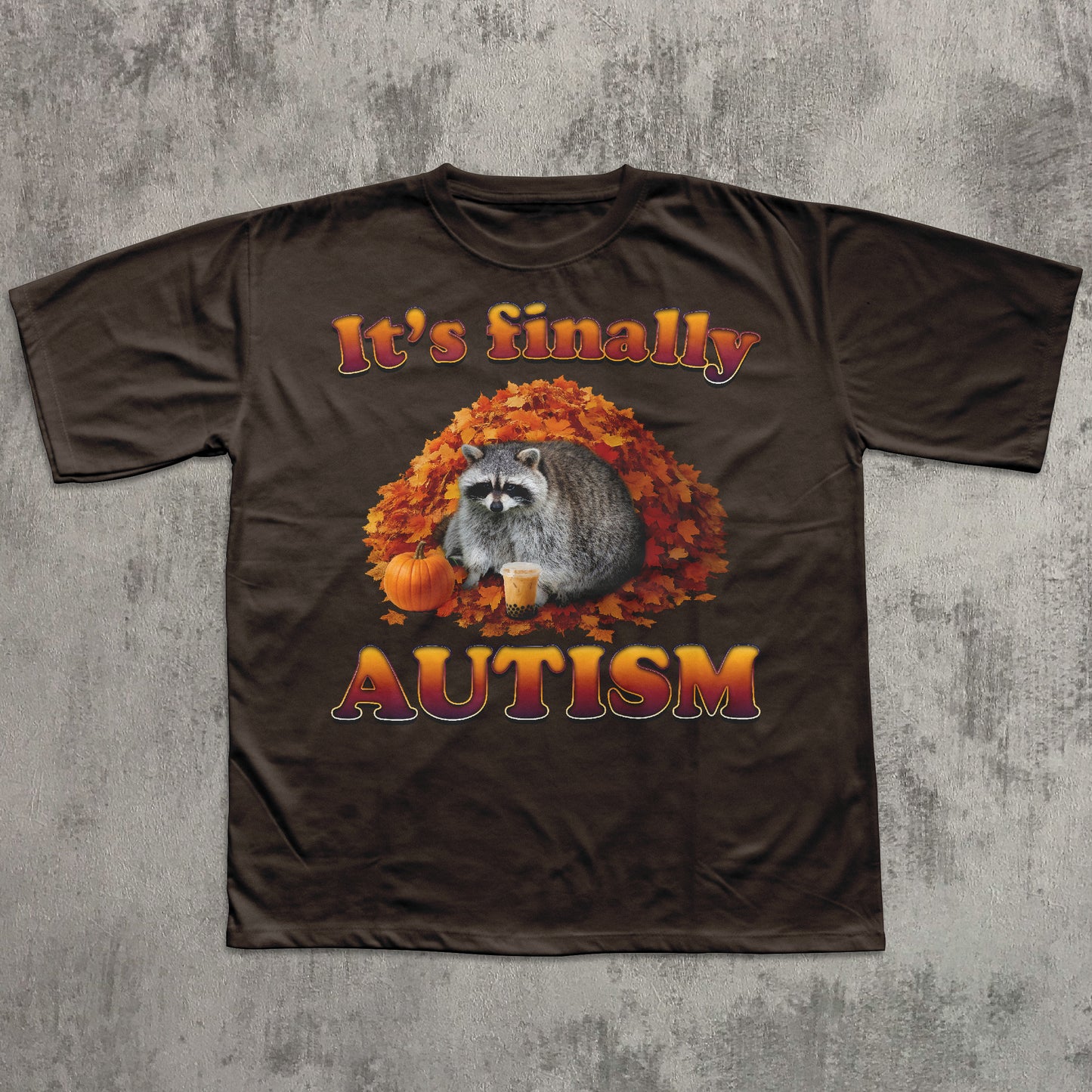 Brown t-shirt with raccoon and autumn design on a textured gray background