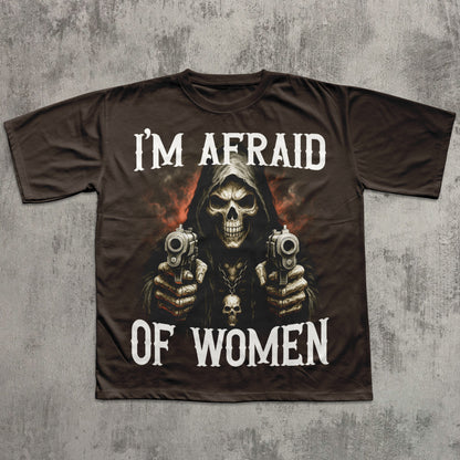 T-shirt with a graphic design of a skeleton holding guns and text 'I'm Afraid of Women' on a textured gray background.