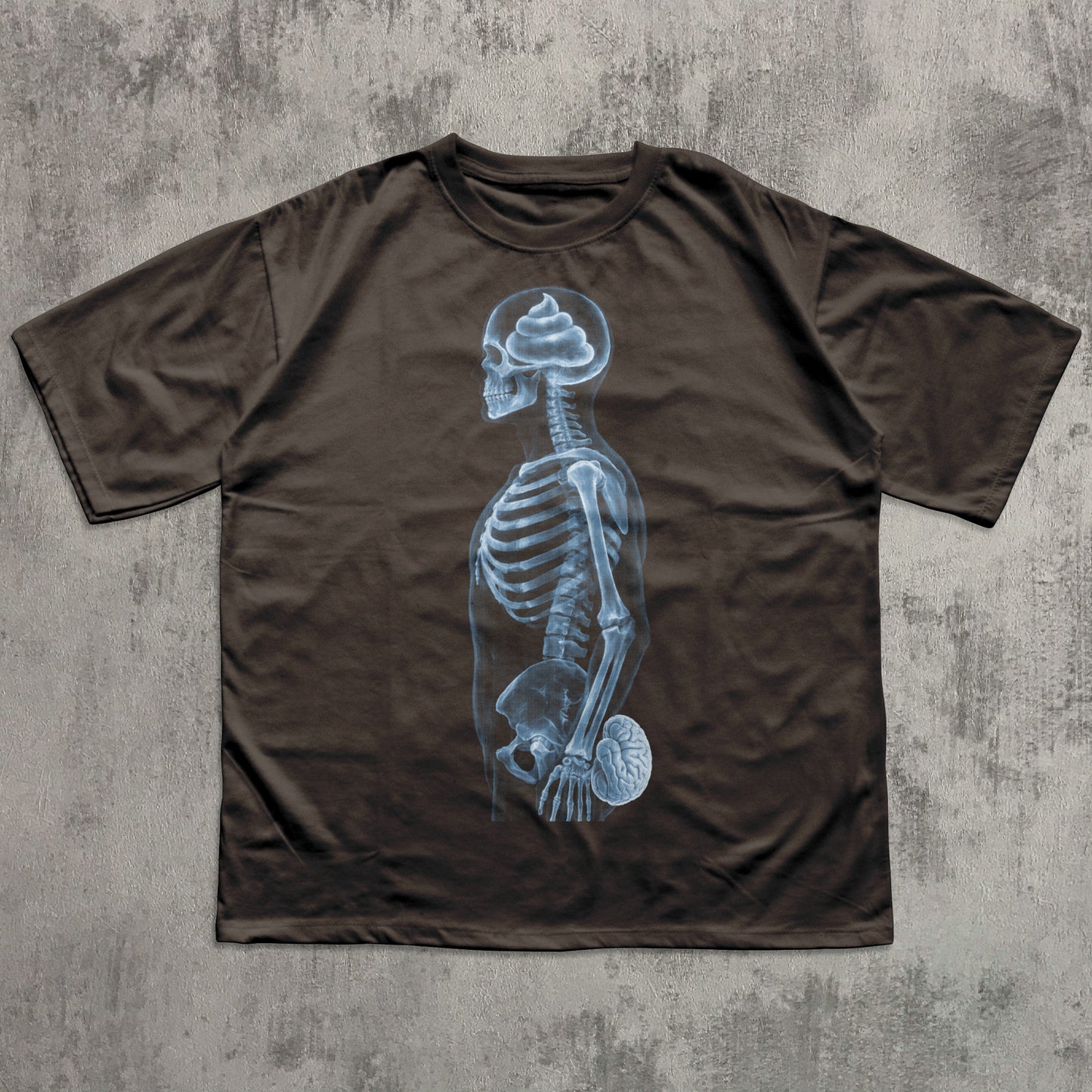 Humorous chocolate graphic T-shirt featuring a blue X-ray skeleton with a poop-shaped brain in the skull and the brain held at the crotch, funny anatomy joke shirt