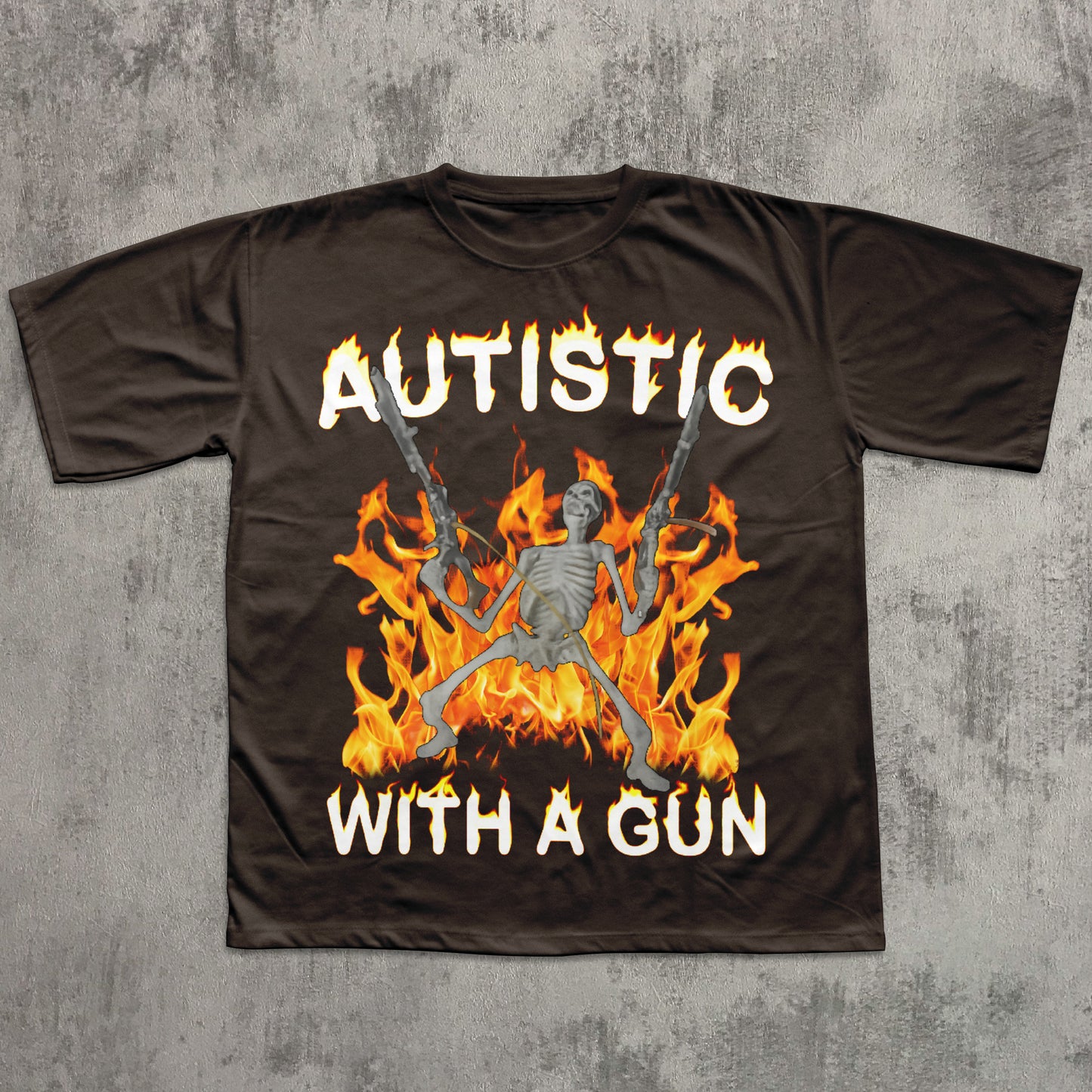 Brown t-shirt with a graphic design of a skeleton in flames holding guns and text 'AUTISTIC WITH A GUN' on a concrete surface.