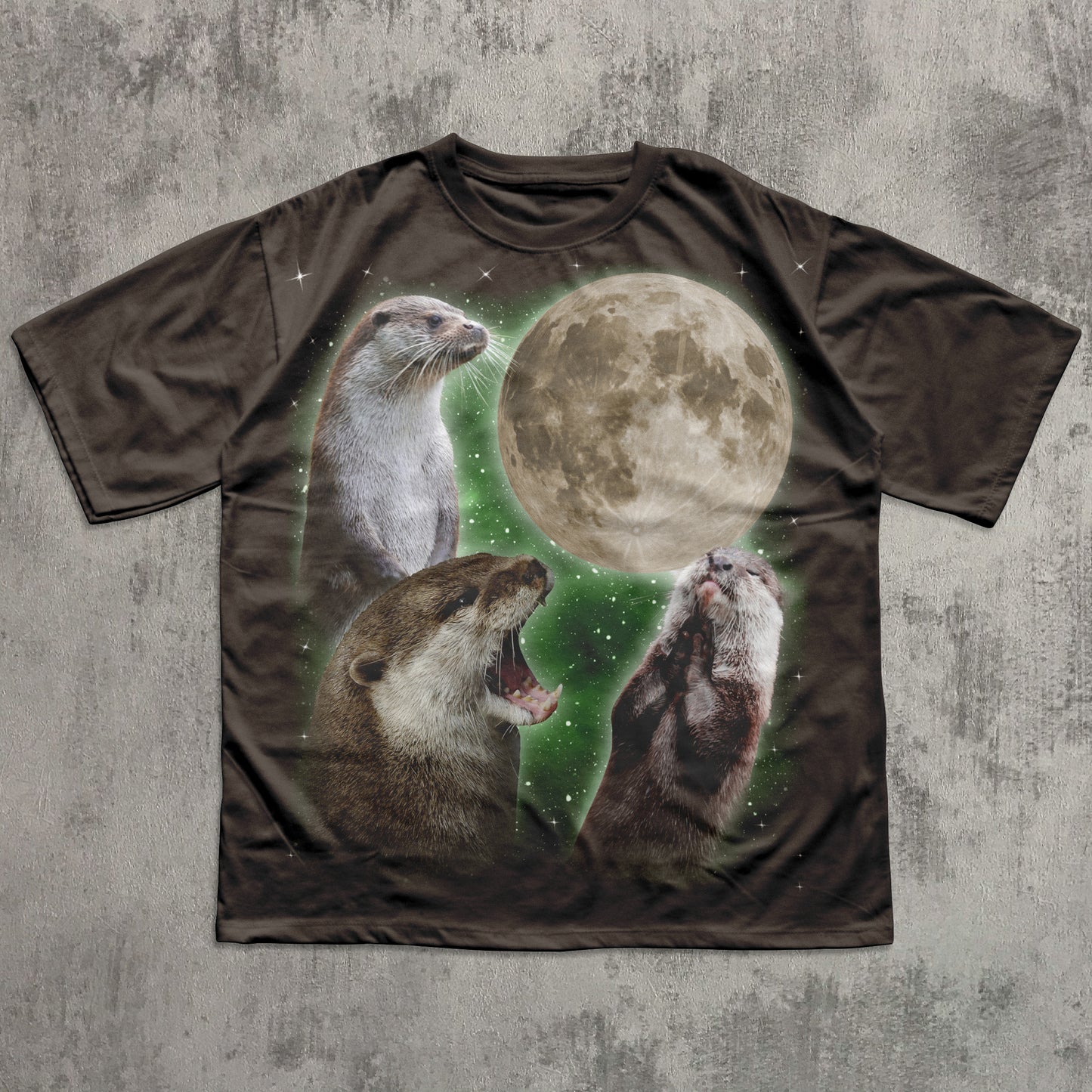 T-shirt with otter and moon design on a textured surface