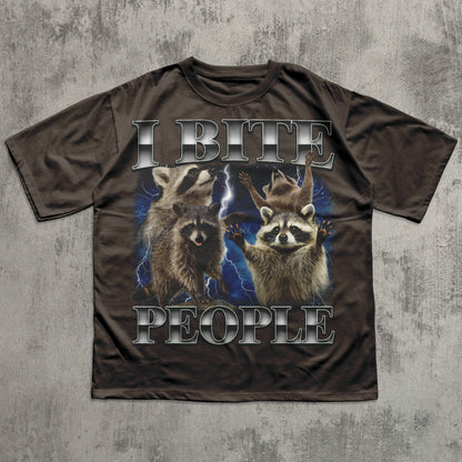 T-shirt with raccoon graphic and text 'I BITE PEOPLE' on a textured gray background