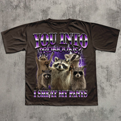 T-shirt with raccoon graphic and humorous text on a textured gray background