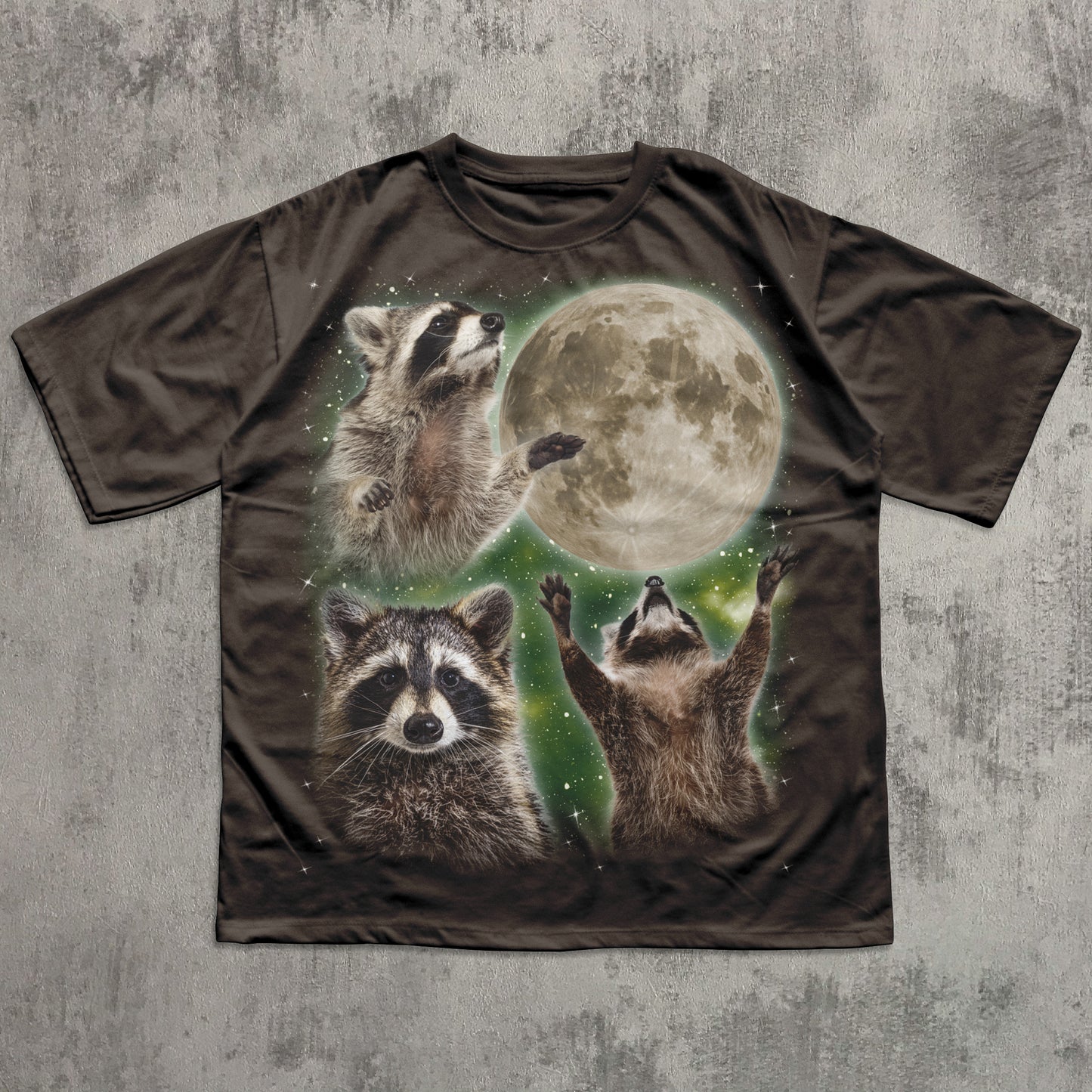 T-shirt with raccoon design and moon on a textured gray background