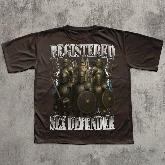 Brown t-shirt with warrior graphic and text 'REGISTERED SEX DEFENDER' on a textured gray background