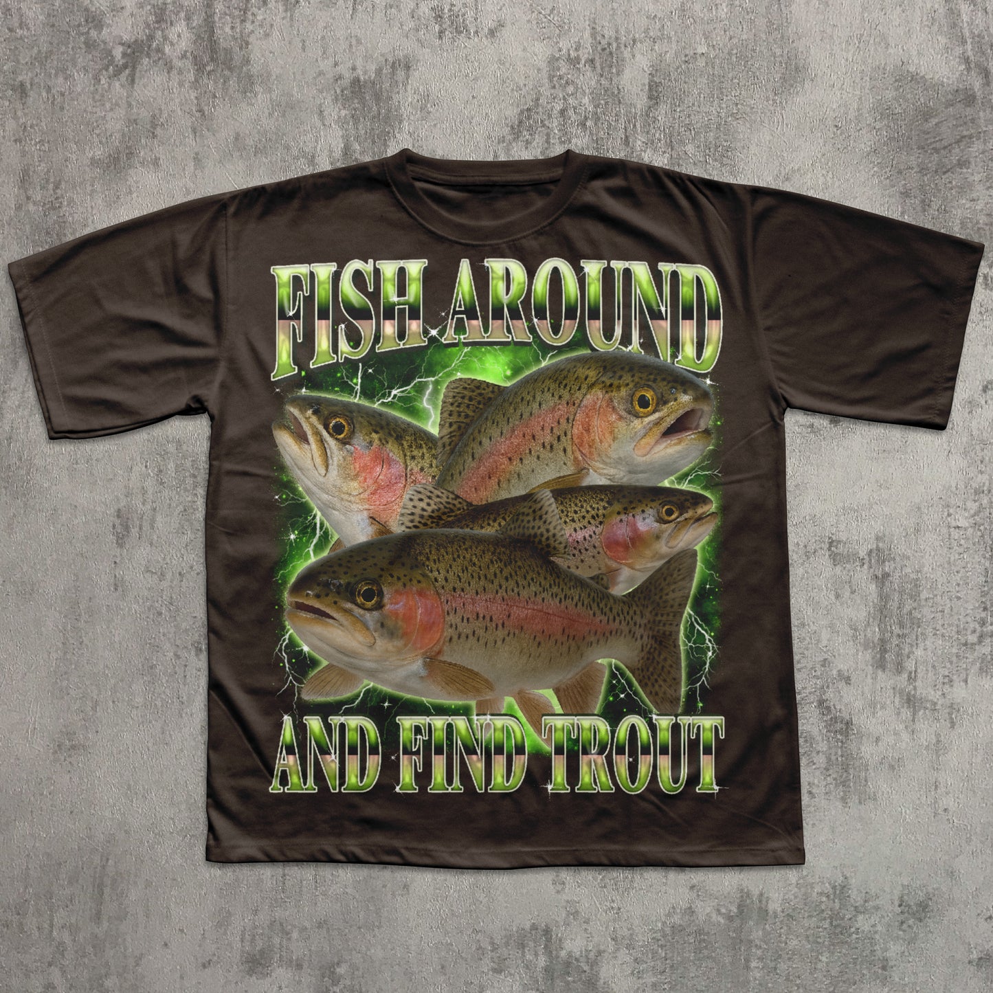 Brown t-shirt with fish graphic and text 'Fish Around And Find Trout' on a textured gray background